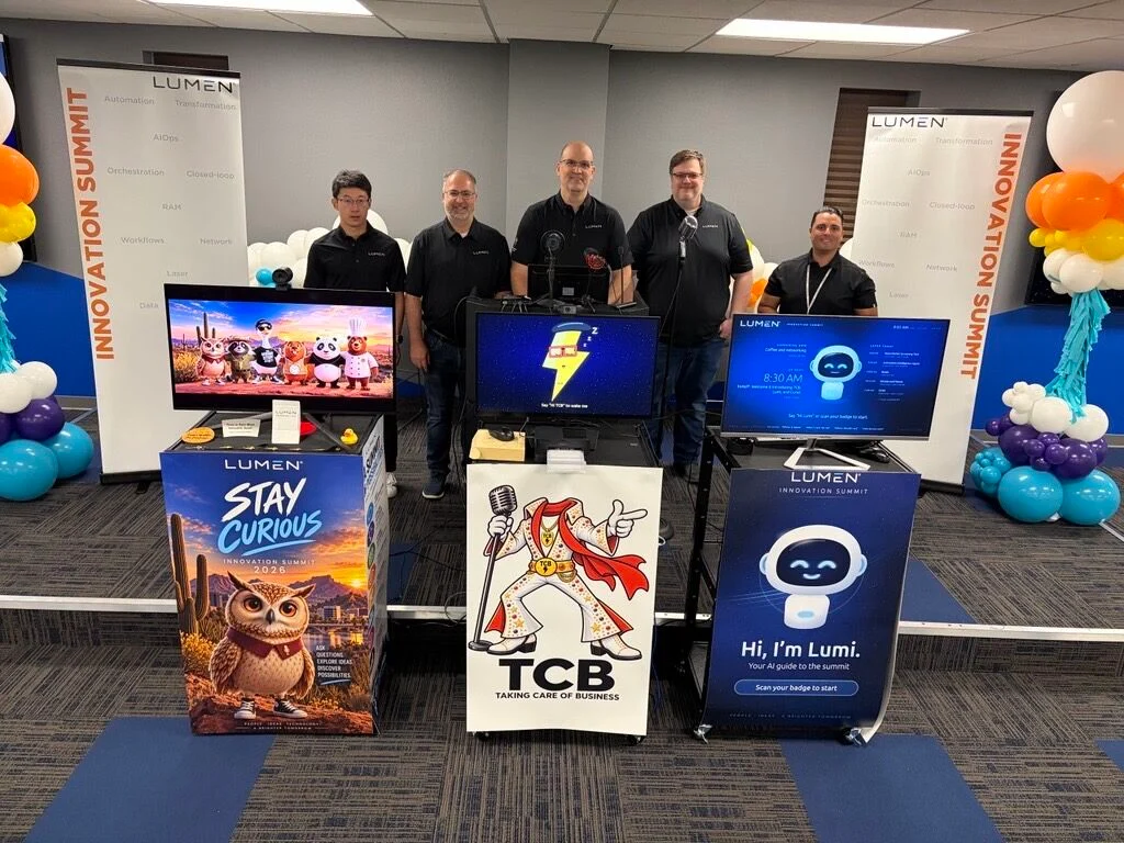 Lumen engineers beside three demonstration kiosks, including the Lumi assistant