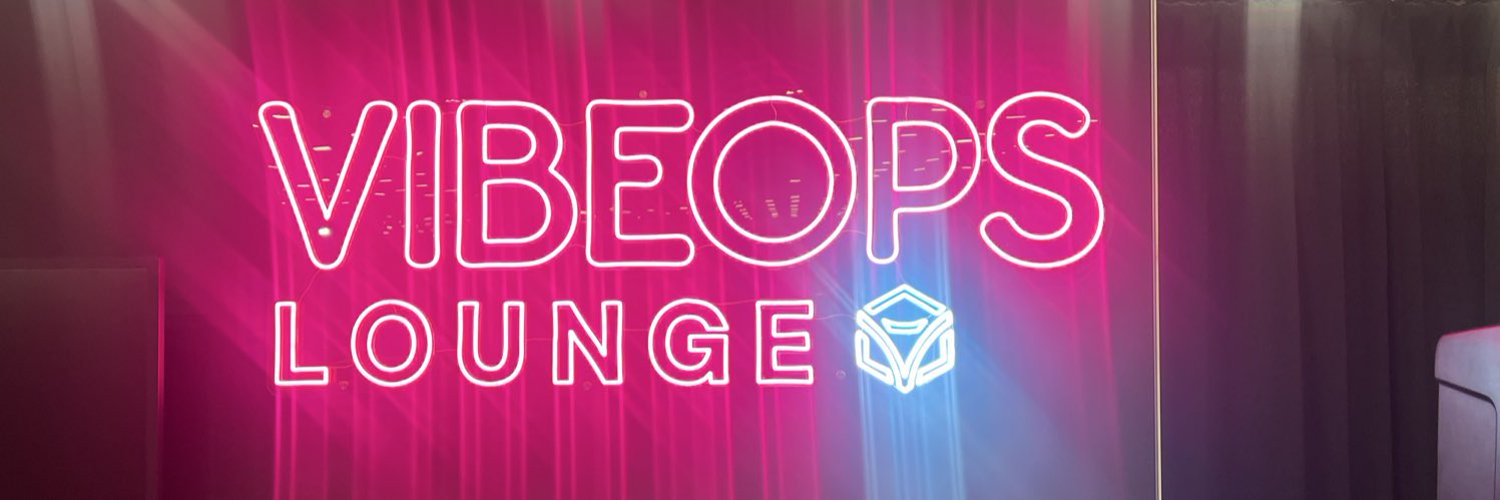 Pink and blue VibeOps Lounge neon sign